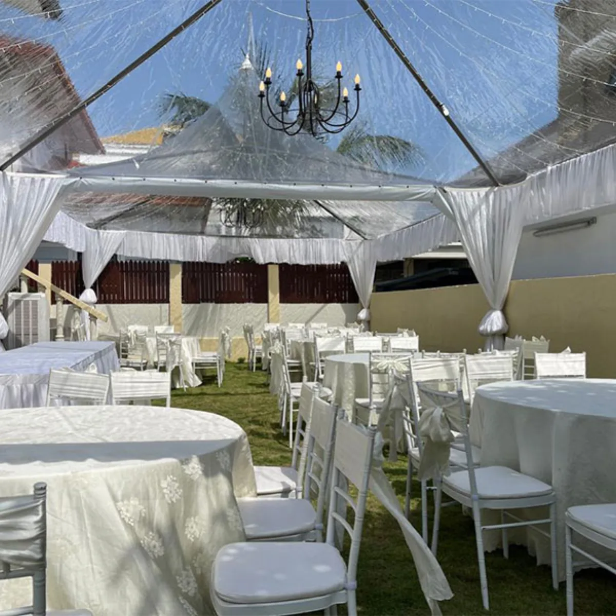 White dining canopy arranged with tables and chairs