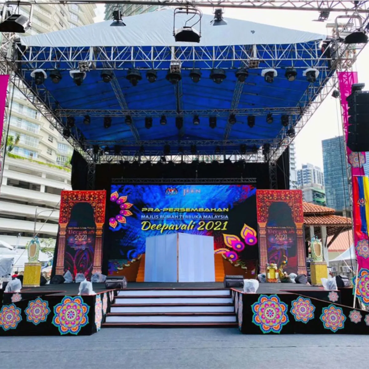 Outdoor public-event stage with LED screen and roof truss