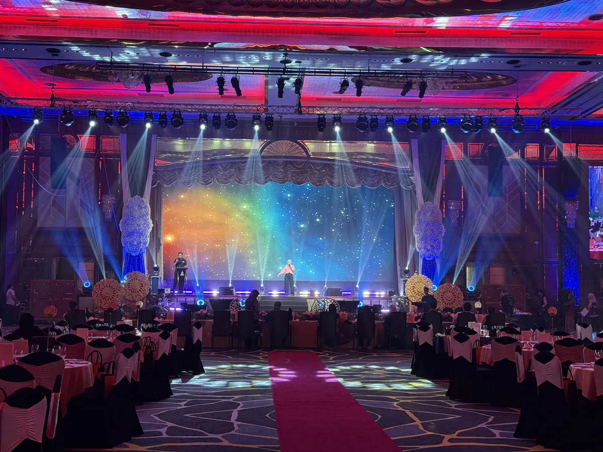 Gala stage with a rainbow LED wall and moving-head beams